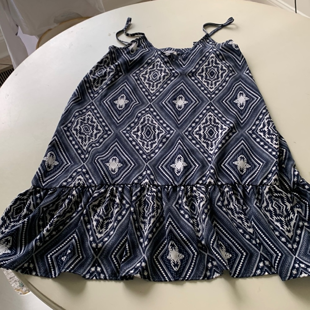 Blue and white dress with ruffle. Elastic a rose the back